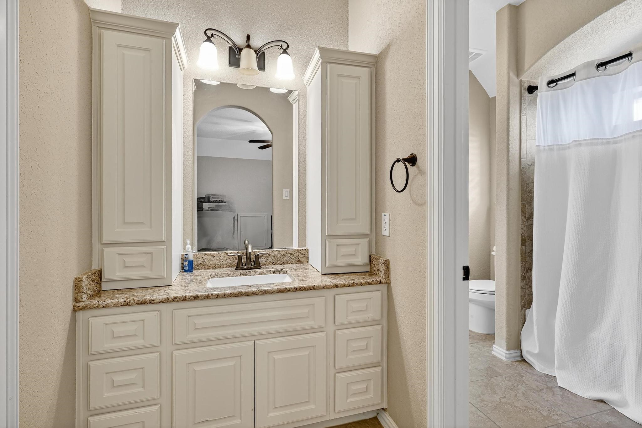 25803 Heritage Maple Drive Spring, TX 77389 - Photo 32 of 46 a bathroom with a granite countertop sink vanity and a mirror