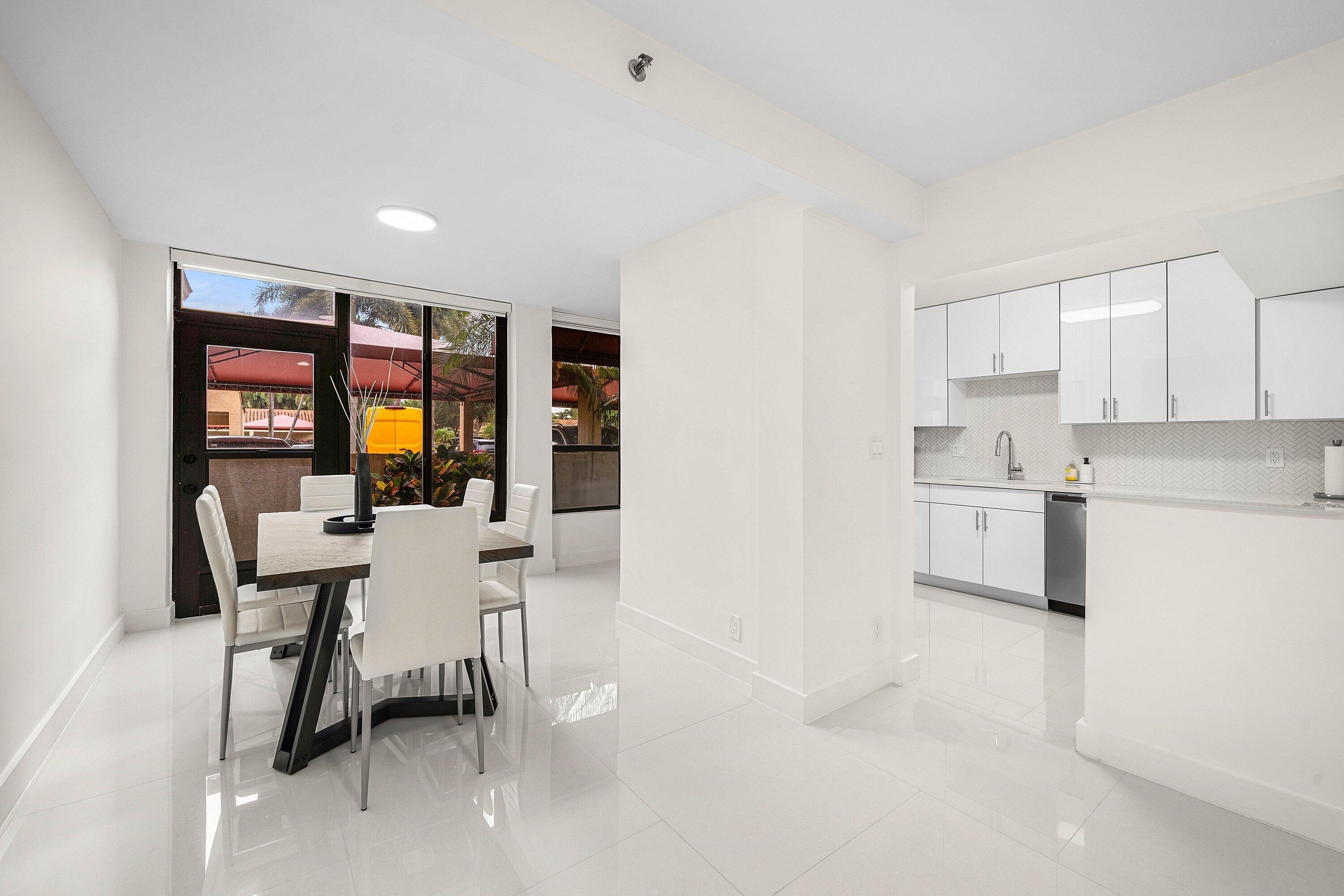 7145 Promenade Drive, Unit 101 Boca Raton, FL 33433 - Photo 11 of 35 a kitchen with a table and chairs