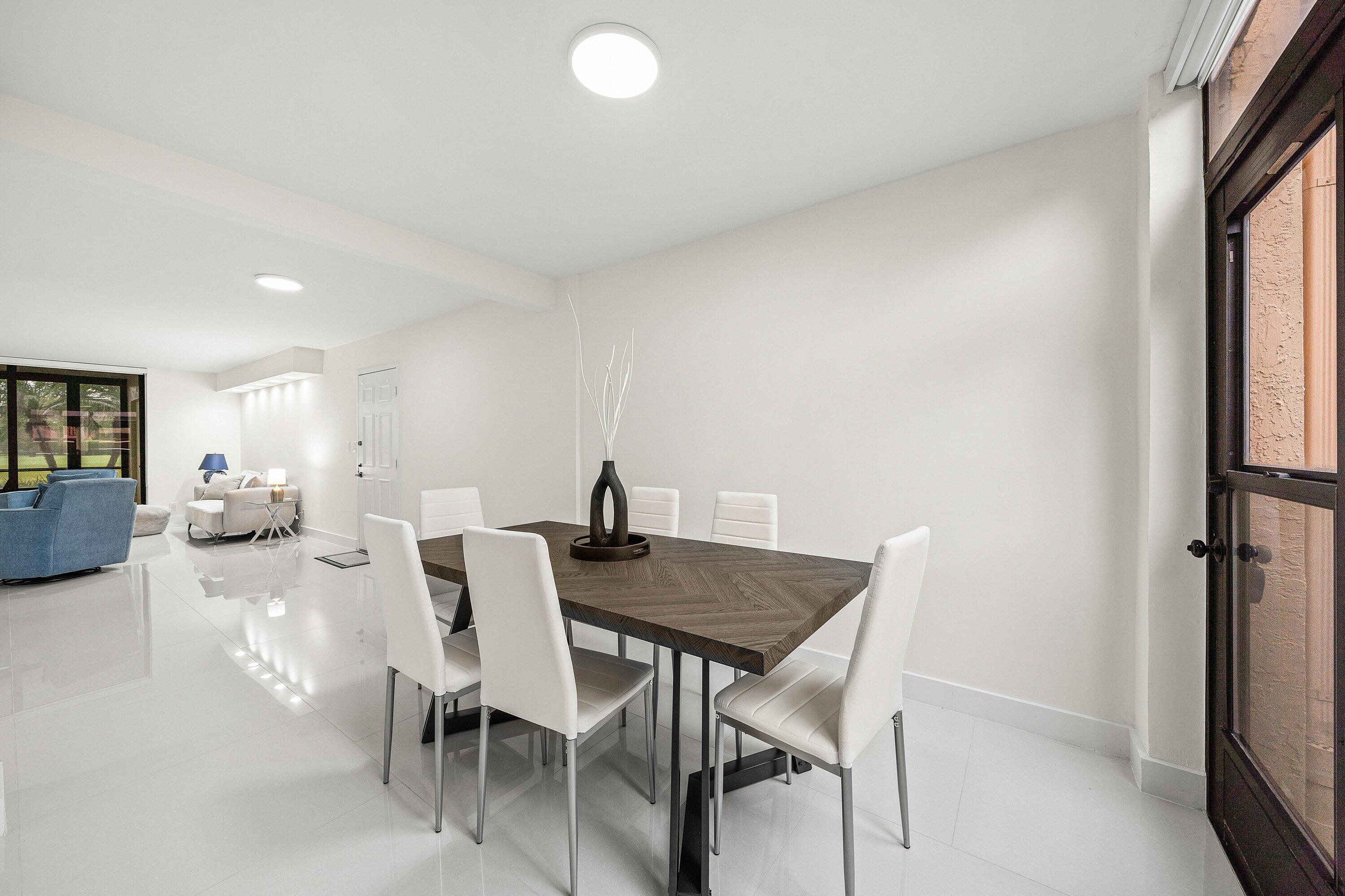 7145 Promenade Drive, Unit 101 Boca Raton, FL 33433 - Photo 15 of 35 a view of a dining room with furniture and a window