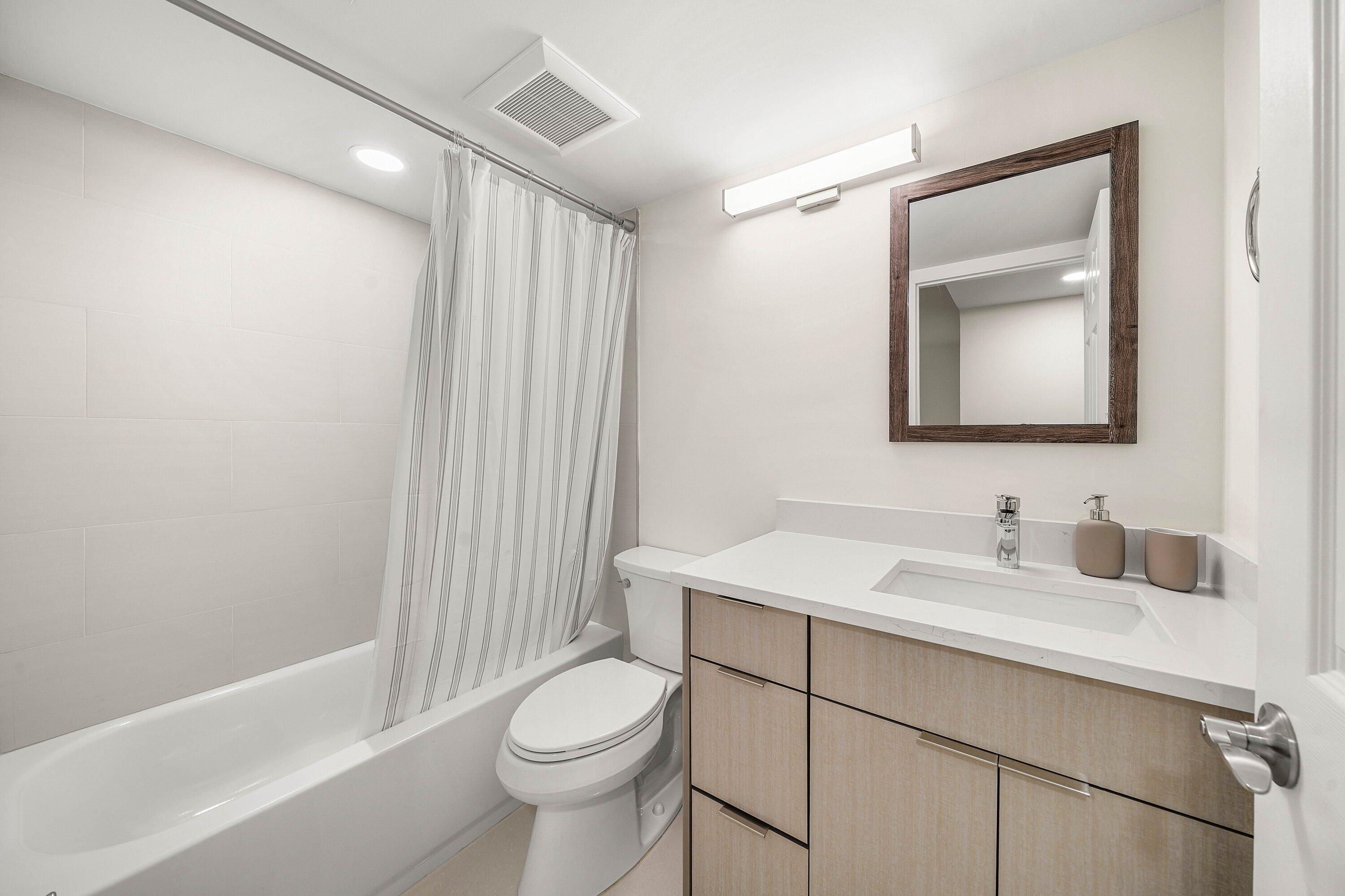 7145 Promenade Drive, Unit 101 Boca Raton, FL 33433 - Photo 16 of 35 a bathroom with a sink a toilet and shower