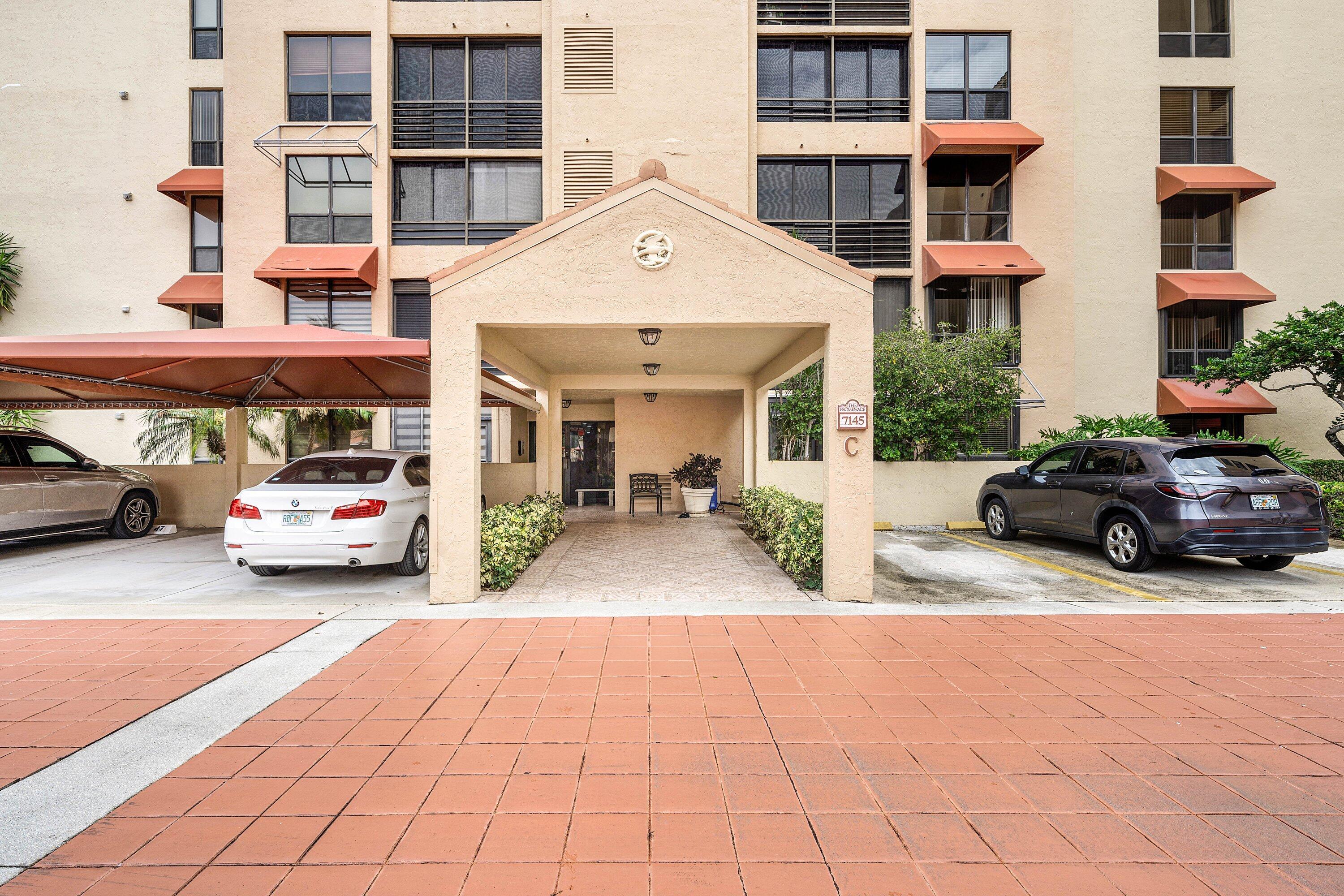 7145 Promenade Drive, Unit 101 Boca Raton, FL 33433 - Photo 2 of 35 a view of a car parked in front of a building