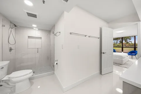 a bathroom with a shower toilet and sink