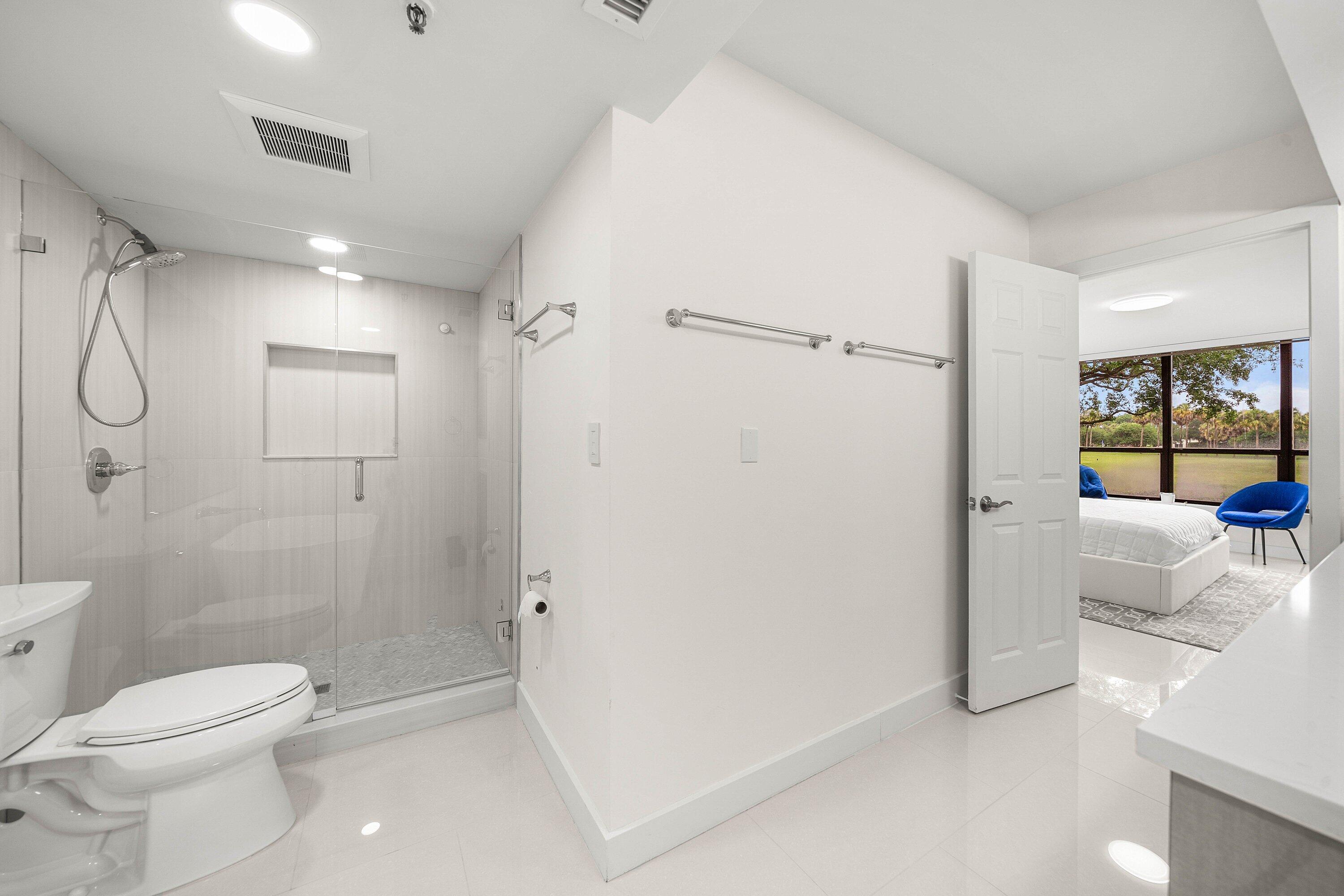 7145 Promenade Drive, Unit 101 Boca Raton, FL 33433 - Photo 23 of 35 a bathroom with a shower toilet and sink