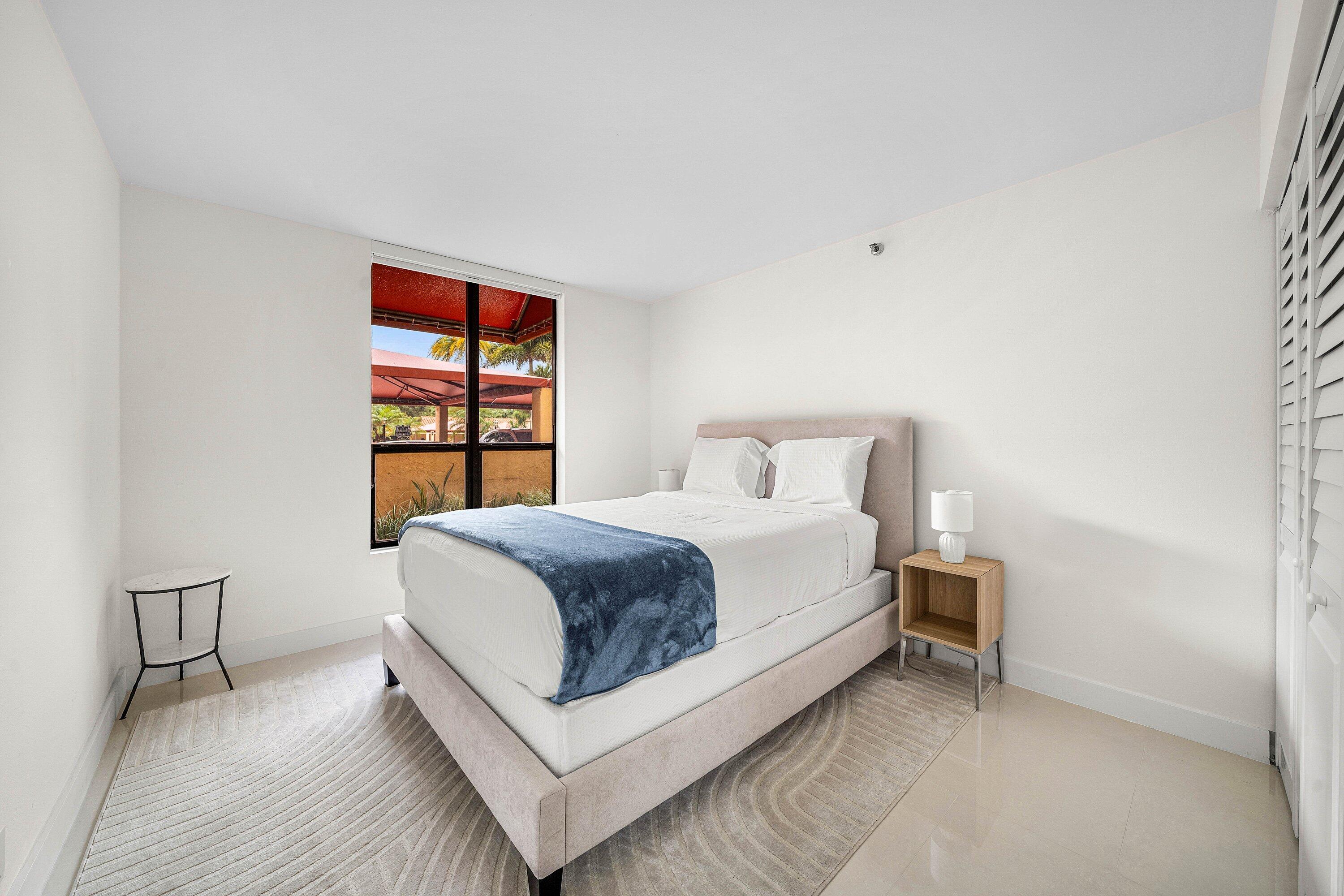 7145 Promenade Drive, Unit 101 Boca Raton, FL 33433 - Photo 25 of 35 a bedroom with a bed and a window