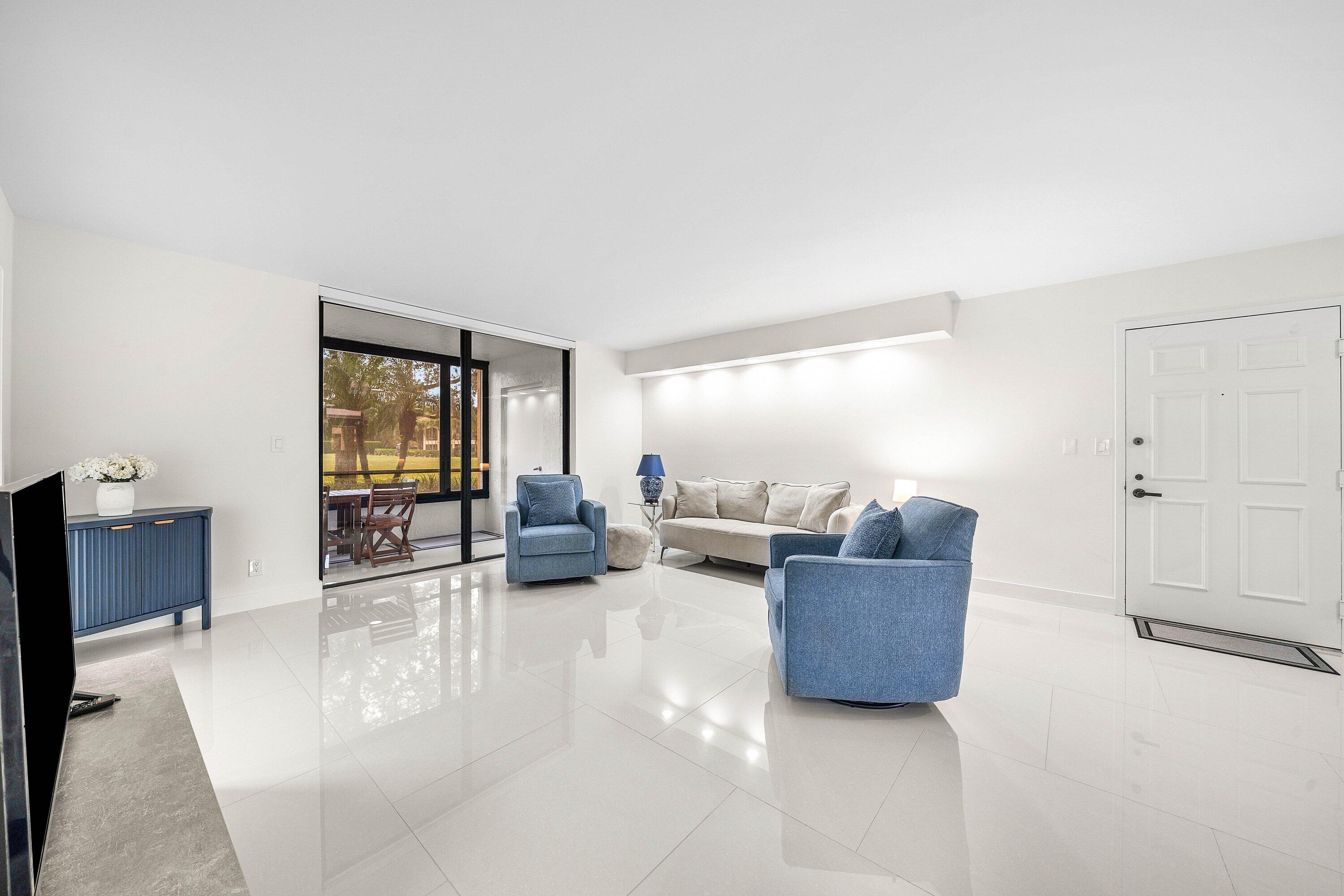 7145 Promenade Drive, Unit 101 Boca Raton, FL 33433 - Photo 5 of 35 a living room with furniture and a window