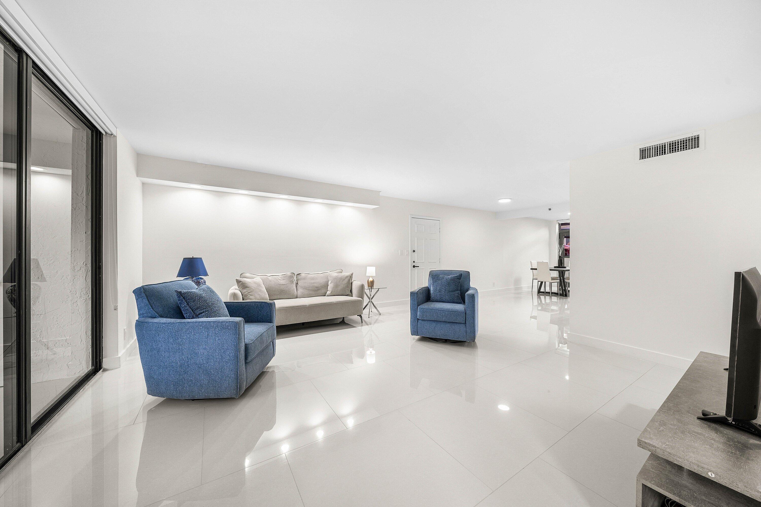 7145 Promenade Drive, Unit 101 Boca Raton, FL 33433 - Photo 6 of 35 a living room with furniture and a flat screen tv