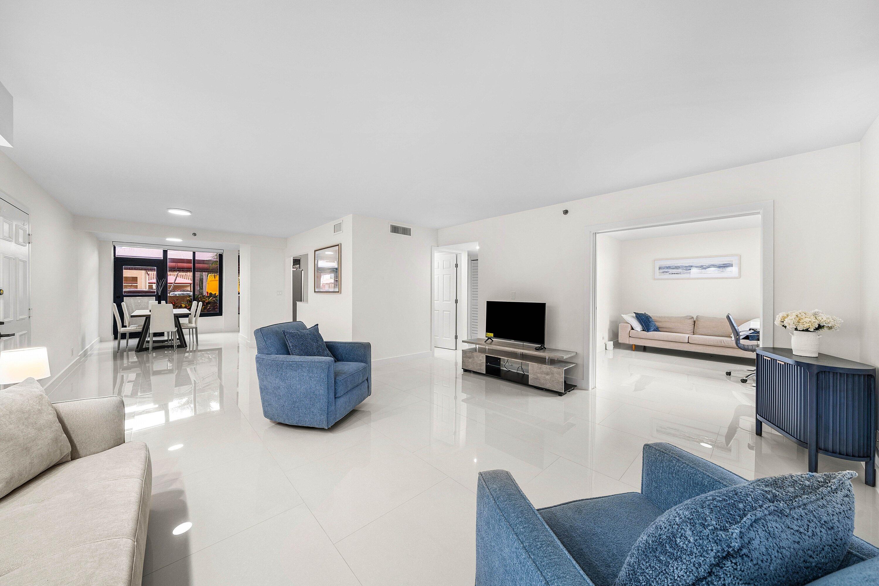 7145 Promenade Drive, Unit 101 Boca Raton, FL 33433 - Photo 7 of 35 a living room with furniture and a flat screen tv