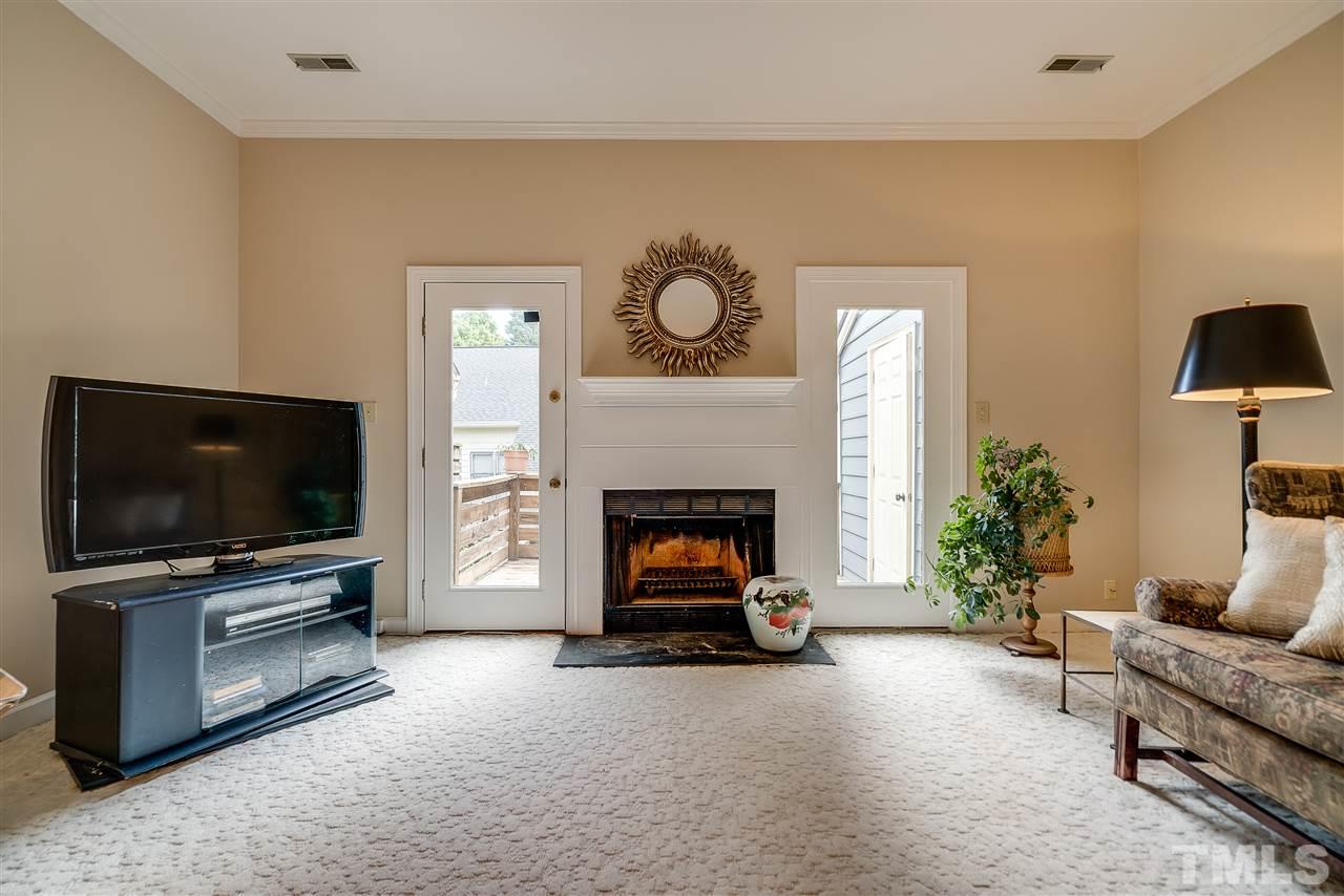 403 Danforth Drive Cary, NC 27511 - Photo 12 of 25 a living room with furniture a flat screen tv and a fireplace