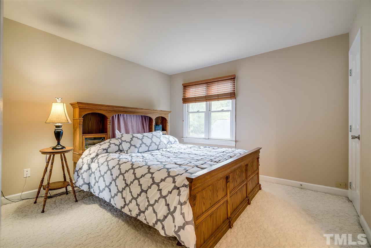403 Danforth Drive Cary, NC 27511 - Photo 15 of 25 a bedroom with a bed and a window