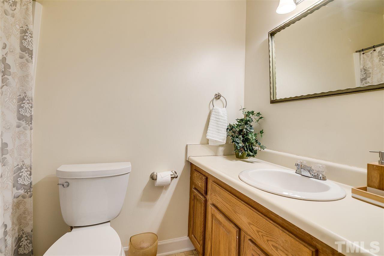 403 Danforth Drive Cary, NC 27511 - Photo 17 of 25 a bathroom with a granite countertop toilet sink and a mirror