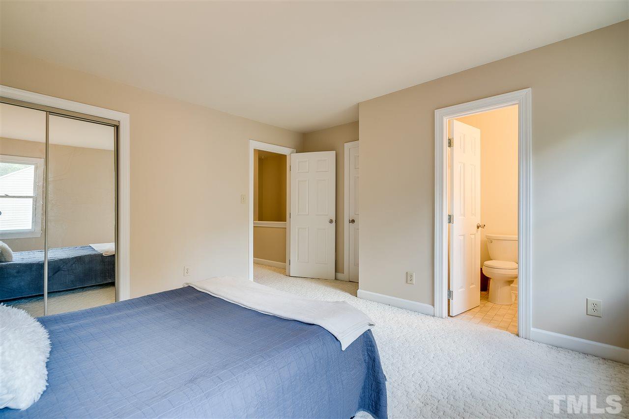 403 Danforth Drive Cary, NC 27511 - Photo 20 of 25 a bedroom with a bed and a walk in closet