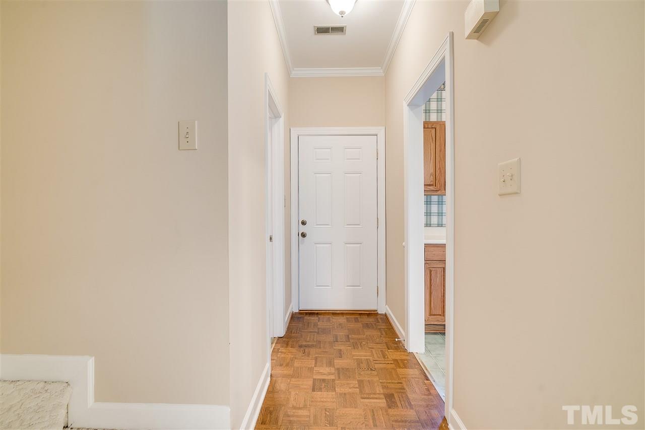 403 Danforth Drive Cary, NC 27511 - Photo 4 of 25 a view of a hallway with wooden floor and a bathroom