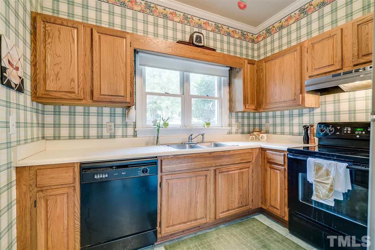 403 Danforth Drive Cary, NC 27511 - Photo 6 of 25 a kitchen with a sink stove and cabinets