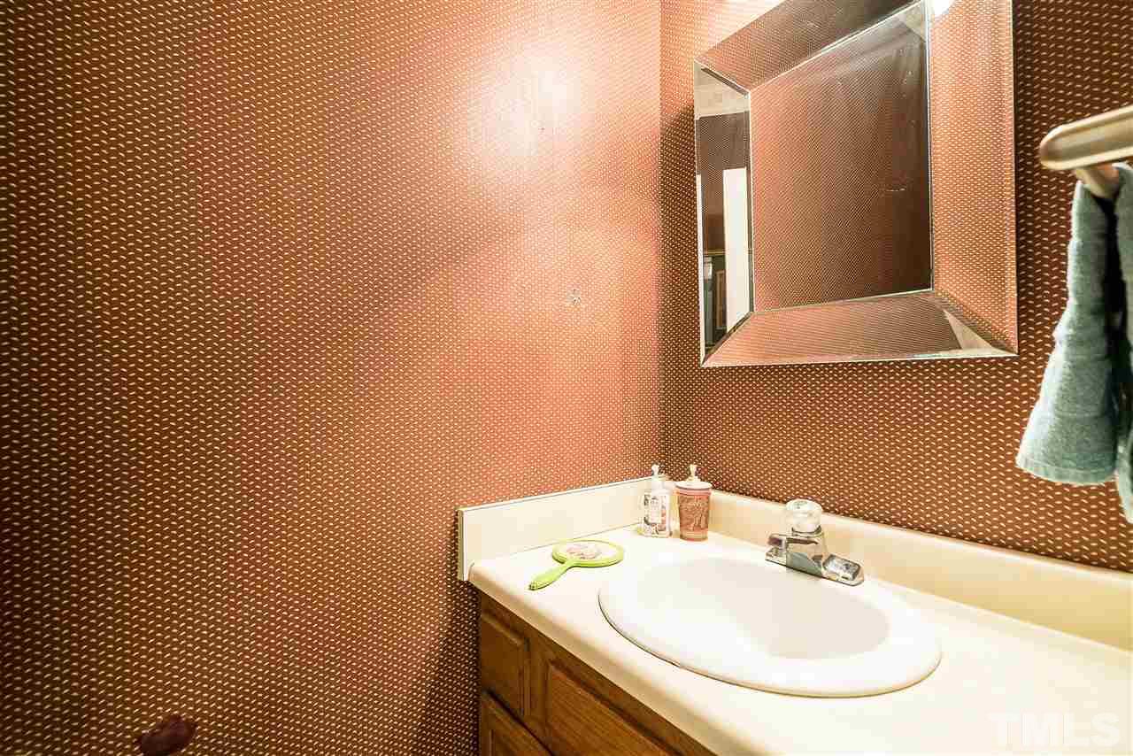403 Danforth Drive Cary, NC 27511 - Photo 7 of 25 a bathroom with a sink and a mirror