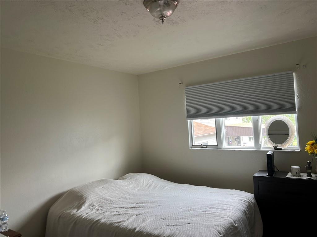 309 Magazine Street Carnegie, PA 15106 - Photo 8 of 18 a bedroom with a bed and a large window