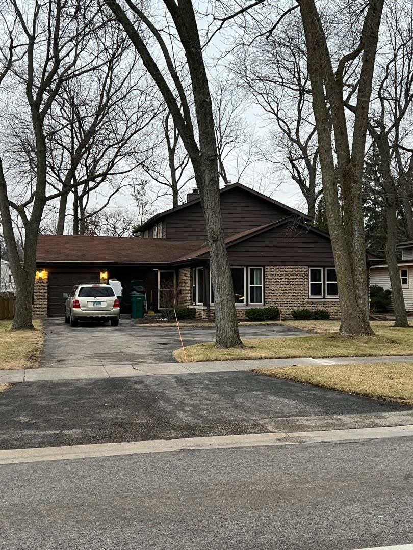 1631 Dundee Road Northbrook, IL 60062 - Photo 1 of 20 a front view of a house with a yard