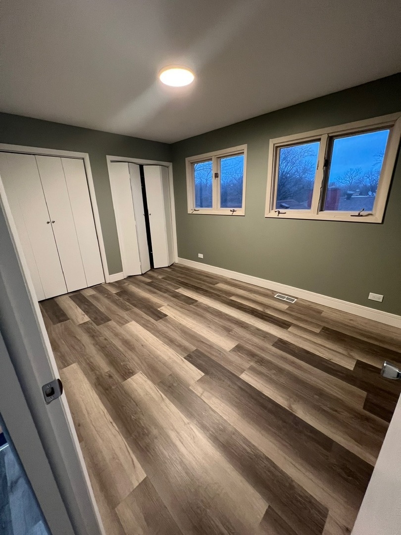 1631 Dundee Road Northbrook, IL 60062 - Photo 12 of 20 a view of an empty room with window and stairs