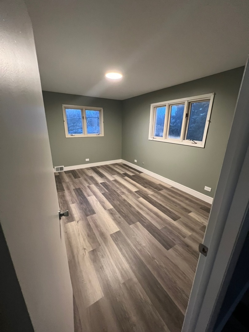 1631 Dundee Road Northbrook, IL 60062 - Photo 14 of 20 a view of empty room with wooden floor