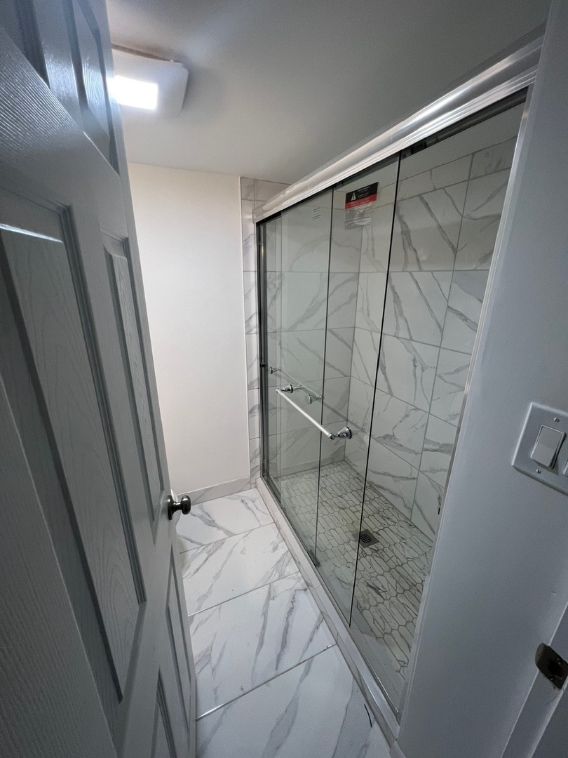 1631 Dundee Road Northbrook, IL 60062 - Photo 18 of 20 a bathroom with a shower and a sink