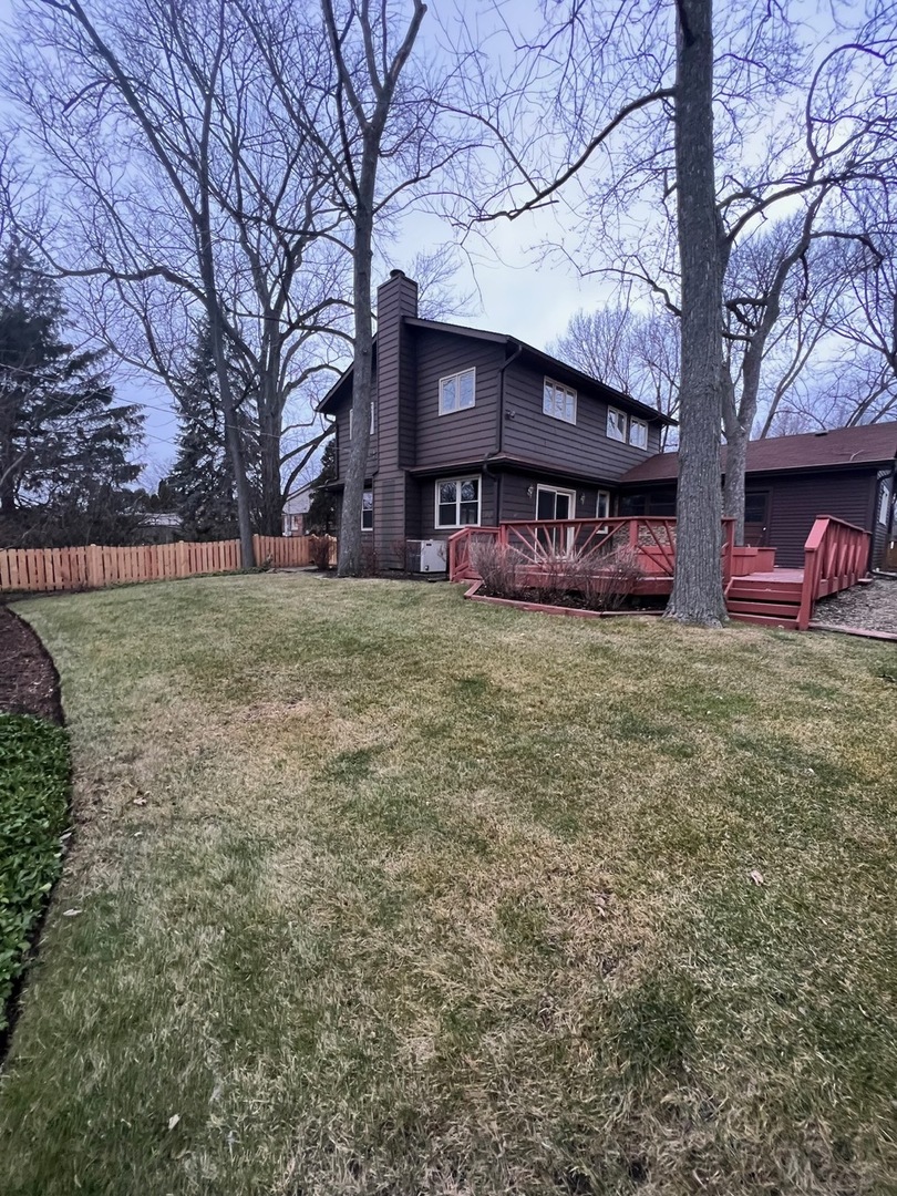 1631 Dundee Road Northbrook, IL 60062 - Photo 2 of 20 a view of a house with a yard and garage