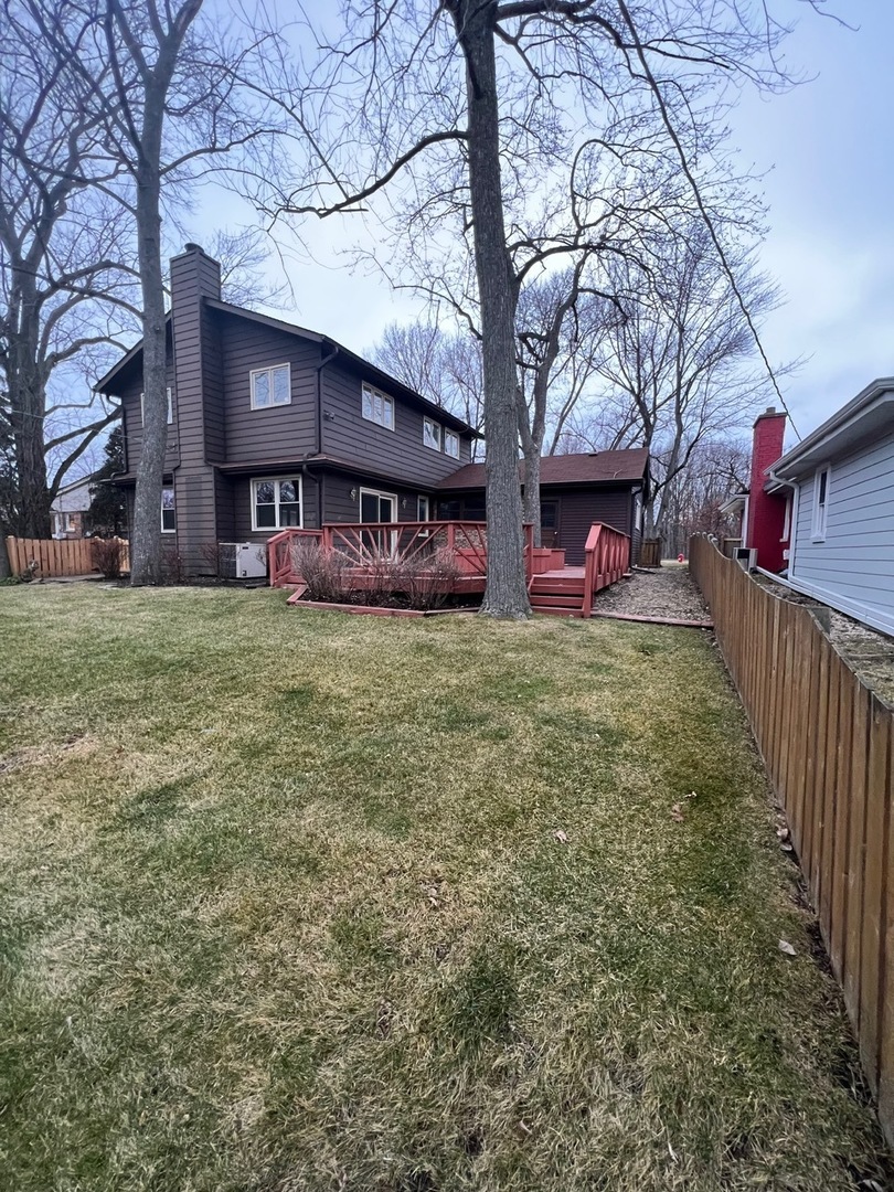 1631 Dundee Road Northbrook, IL 60062 - Photo 3 of 20 a view of a house with a yard and a tree