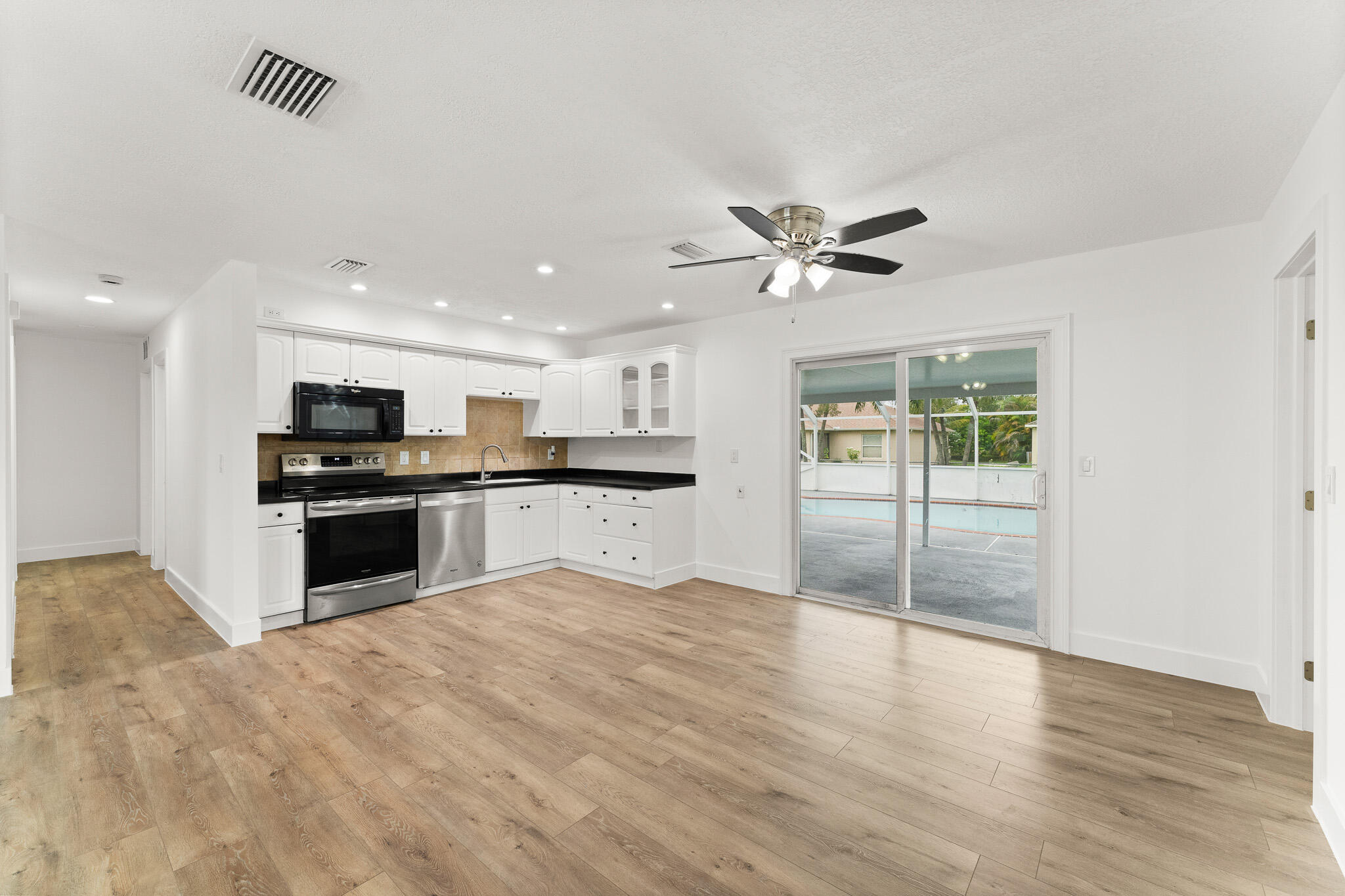 1575 Southwest Fresno Road Port St. Lucie, FL 34953 - Photo 13 of 27 a view of kitchen with refrigerator and ceiling fan