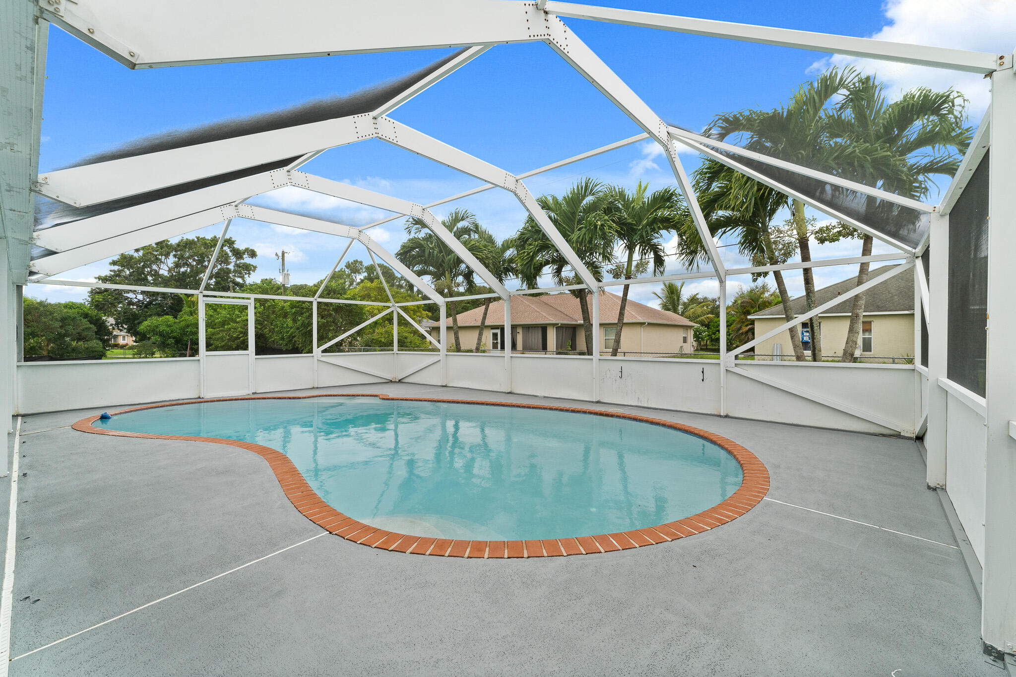 1575 Southwest Fresno Road Port St. Lucie, FL 34953 - Photo 25 of 27 a view of a swimming pool with large windows
