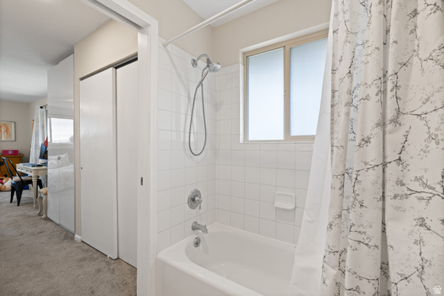 3320 Cherokee Lane Provo, UT 84604 - Photo 29 of 52 Bathtub with white tile surround, frosted window, and chrome fixtures