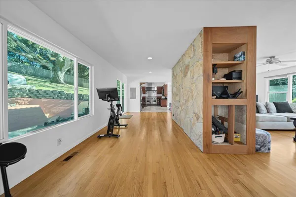 a view of a hallway with wooden floor and staircase