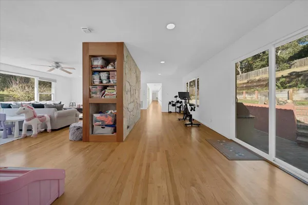 a living room with couches and a view of kitchen