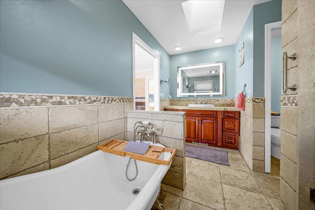 70 Corral De Tierra Road Salinas, CA 93908 - Photo 31 of 55 a bathroom with a tub a sink and mirror