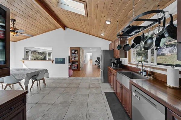 a view of a dining room with furniture and a chandelier