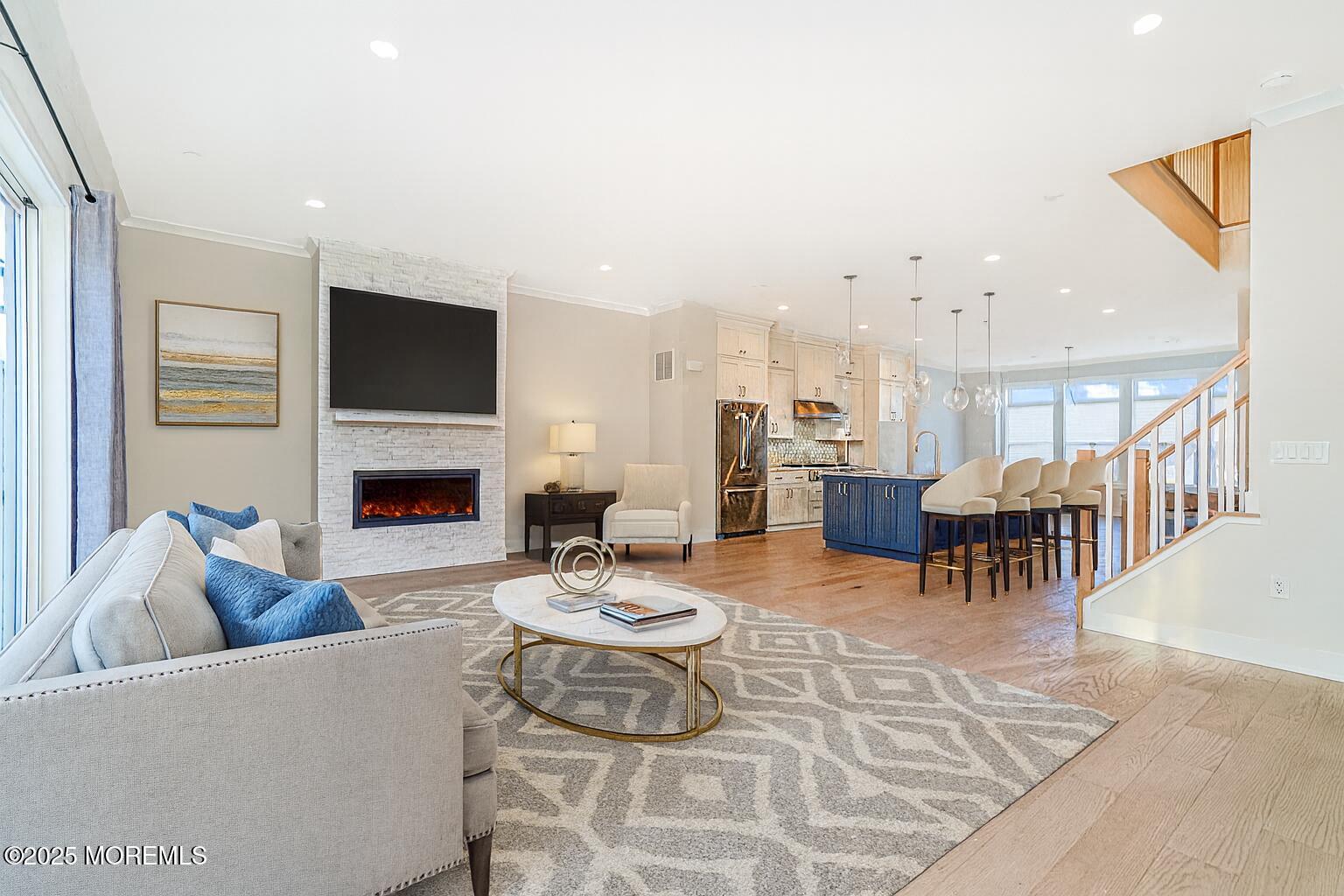22 Edmund Way Middletown, NJ 07748 - Photo 16 of 49 a living room with furniture a fireplace and a flat screen tv