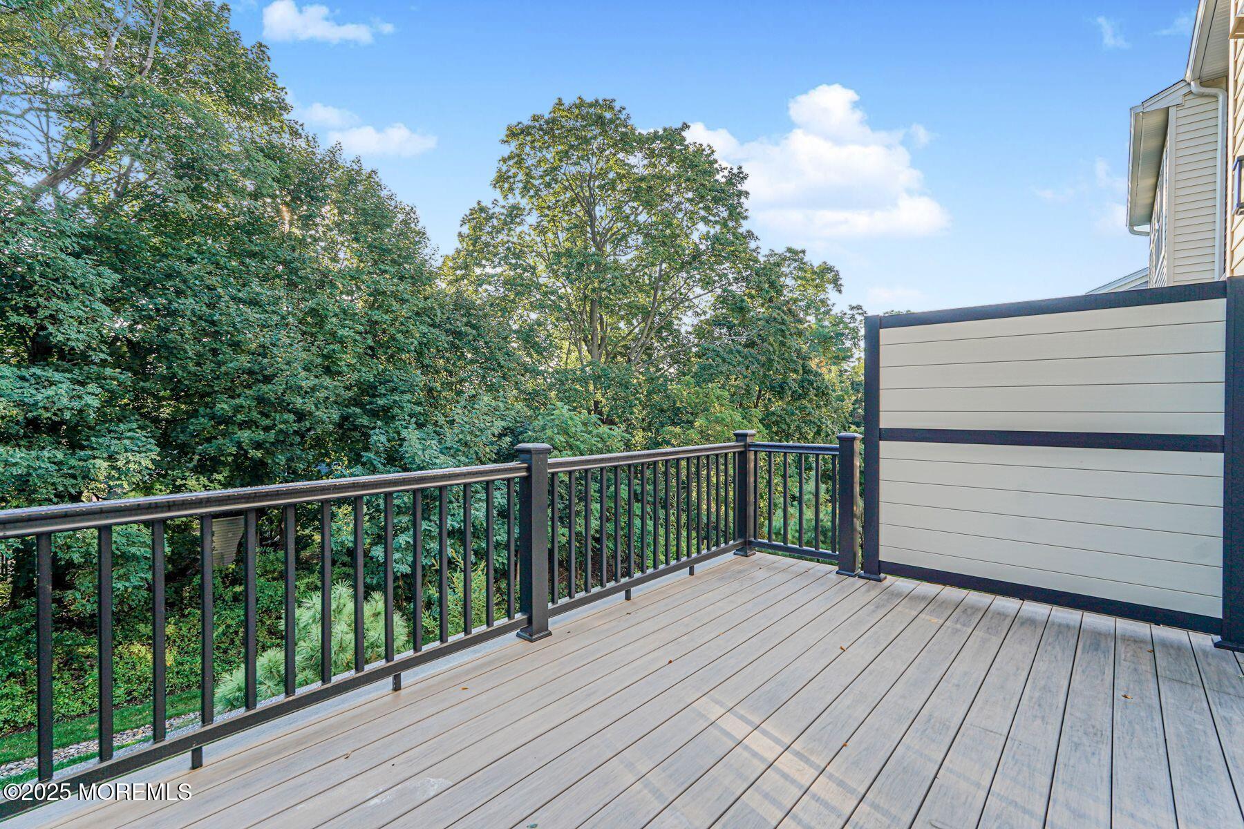 22 Edmund Way Middletown, NJ 07748 - Photo 17 of 49 a balcony with wooden floor and fence