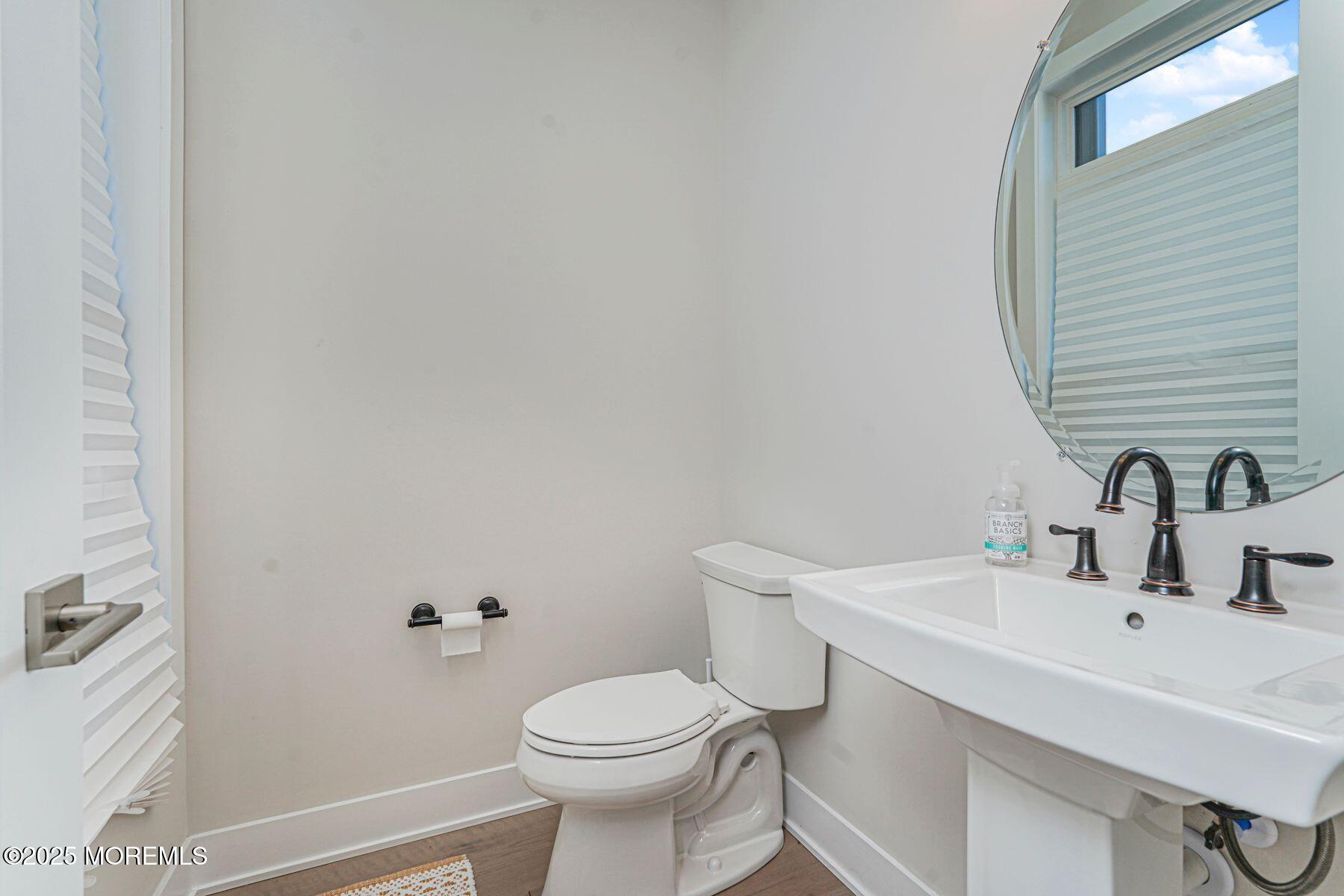 22 Edmund Way Middletown, NJ 07748 - Photo 20 of 49 a bathroom with a sink a toilet and a mirror