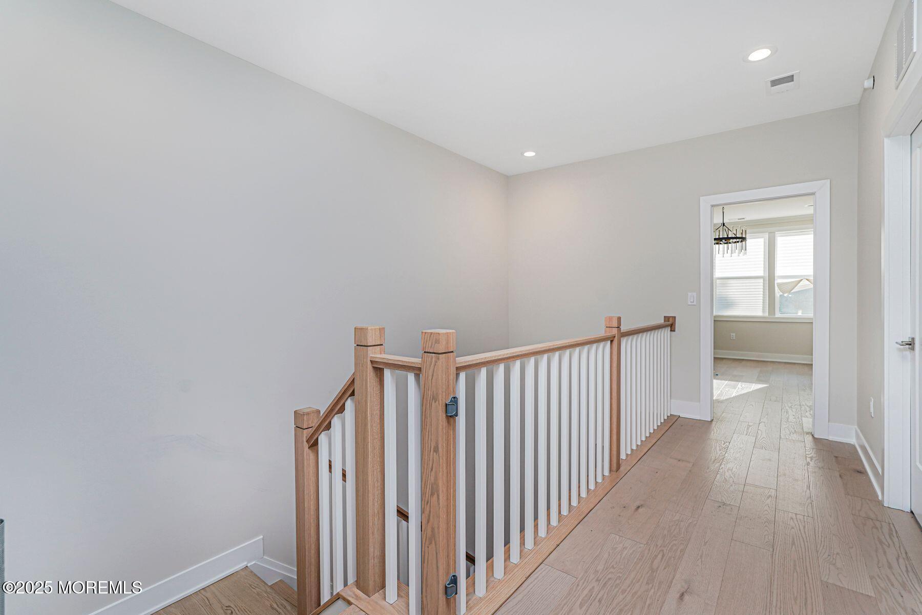 22 Edmund Way Middletown, NJ 07748 - Photo 22 of 49 a view of a hallway with wooden floor