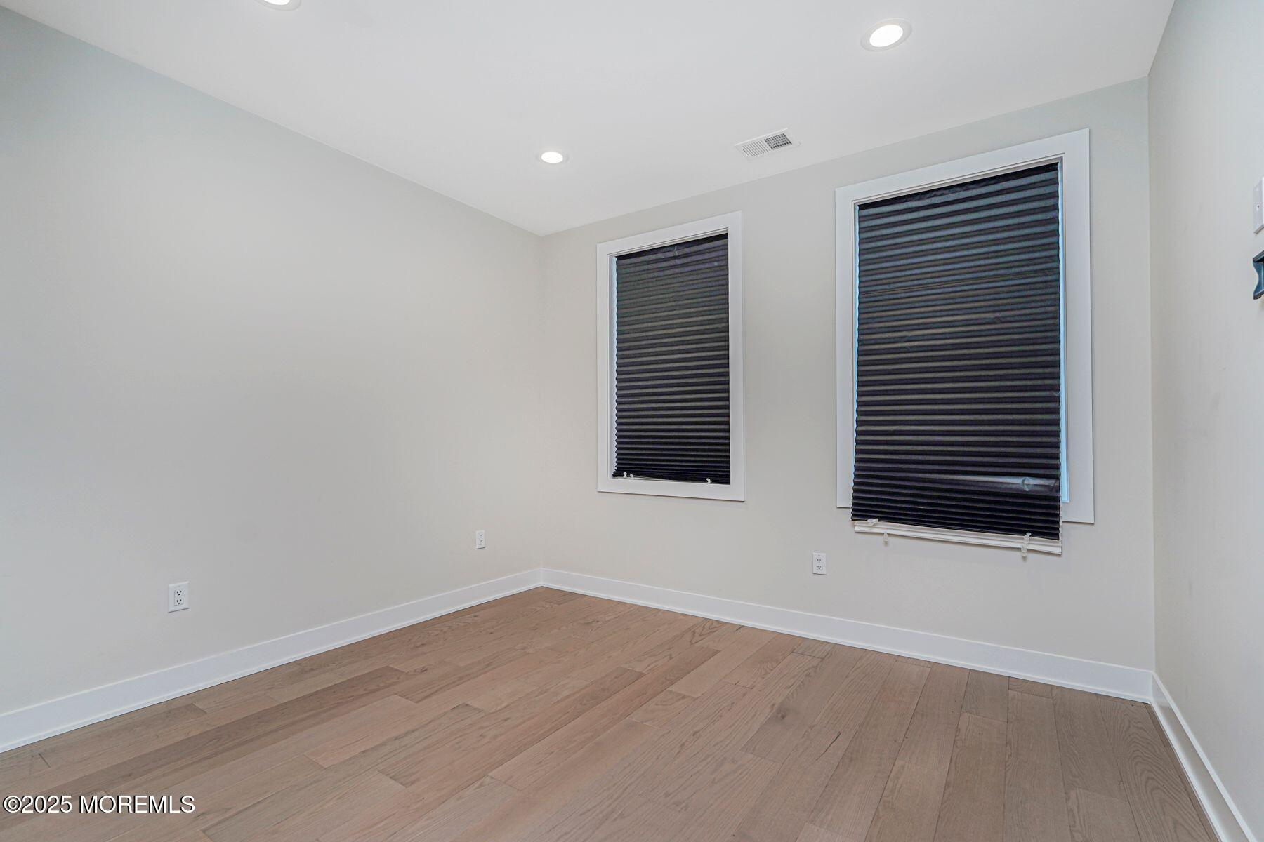 22 Edmund Way Middletown, NJ 07748 - Photo 30 of 49 a view of an empty room with wooden floor and a window