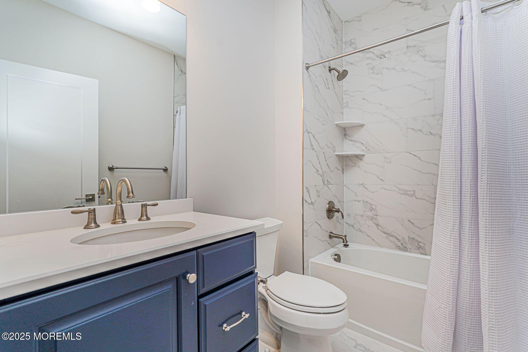 22 Edmund Way Middletown, NJ 07748 - Photo 40 of 49 a bathroom with a sink a toilet and shower