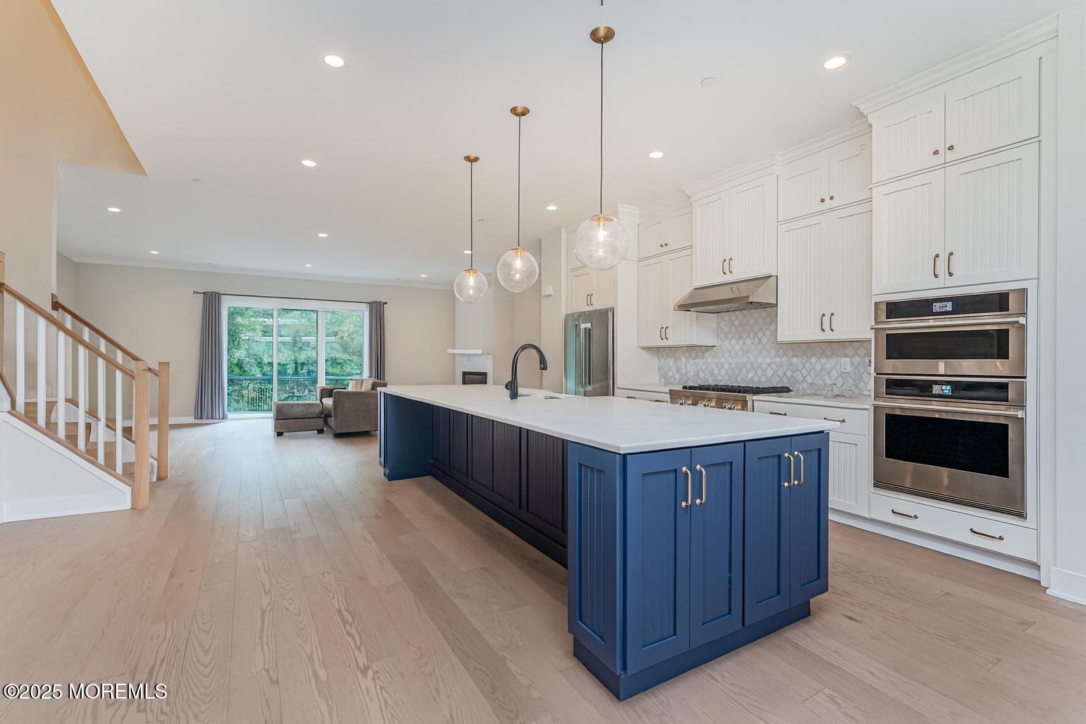 22 Edmund Way Middletown, NJ 07748 - Photo 6 of 49 a large kitchen with kitchen island granite countertop a large center island a sink stainless steel appliances and cabinets