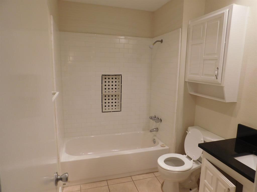 10371 White Elm Road Dallas, TX 75243 - Photo 9 of 11 Full bath with shower combination, light tile patterned floors, and vanity