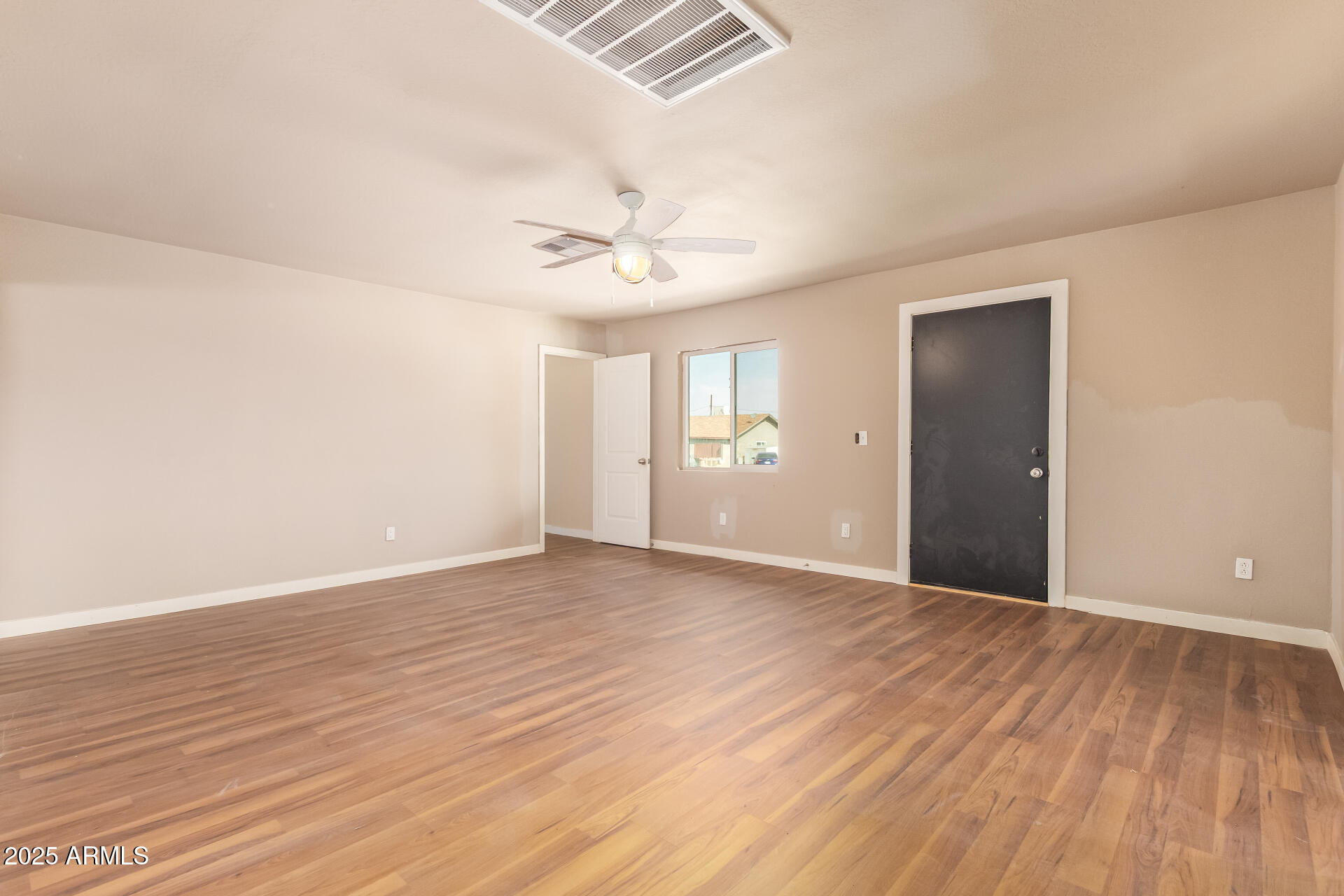 3527 West Almeria Road Phoenix, AZ 85009 - Photo 12 of 32 wooden floor in an empty room with a window