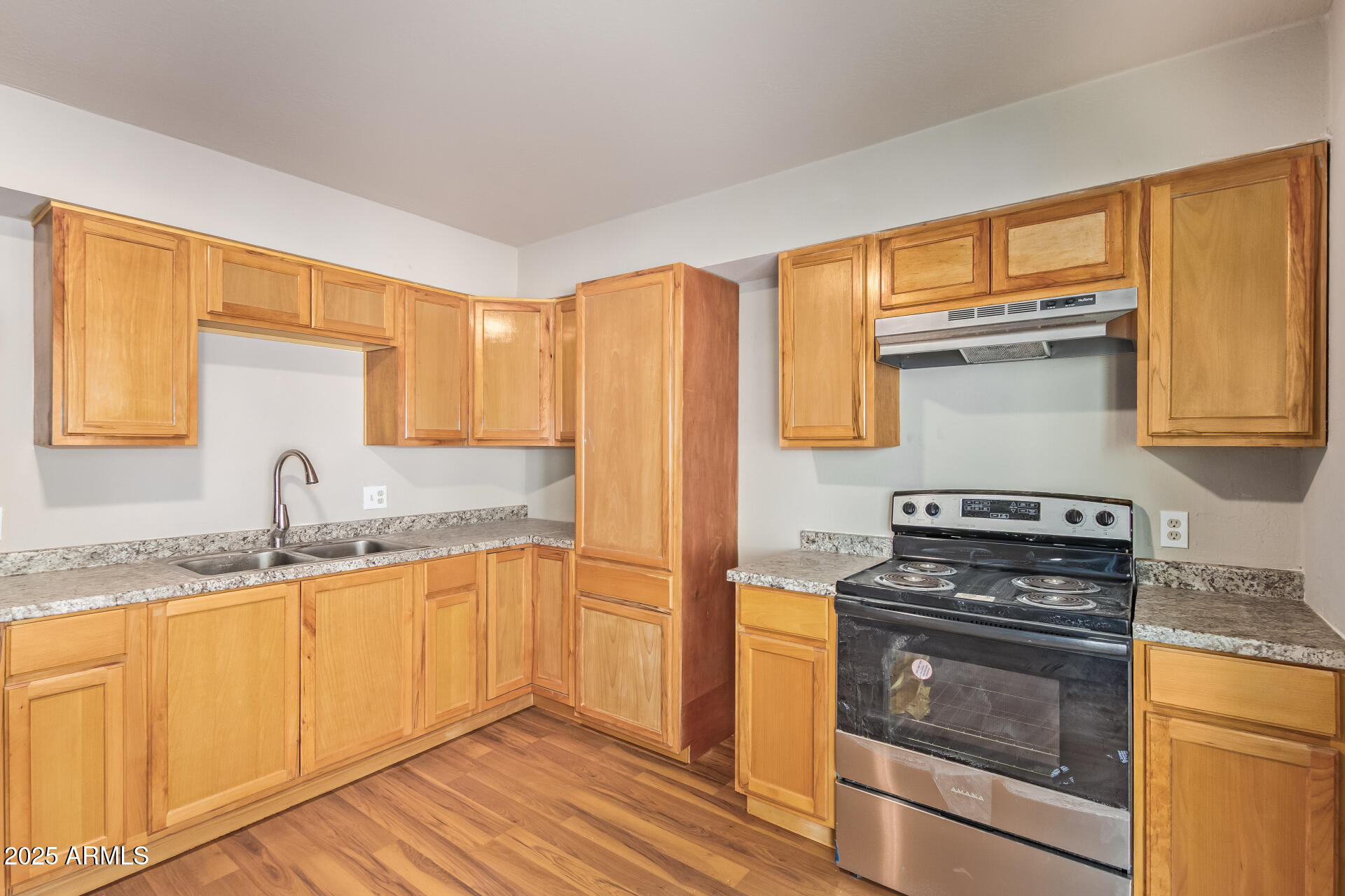 3527 West Almeria Road Phoenix, AZ 85009 - Photo 14 of 32 a kitchen with granite countertop a sink stainless steel appliances and cabinets