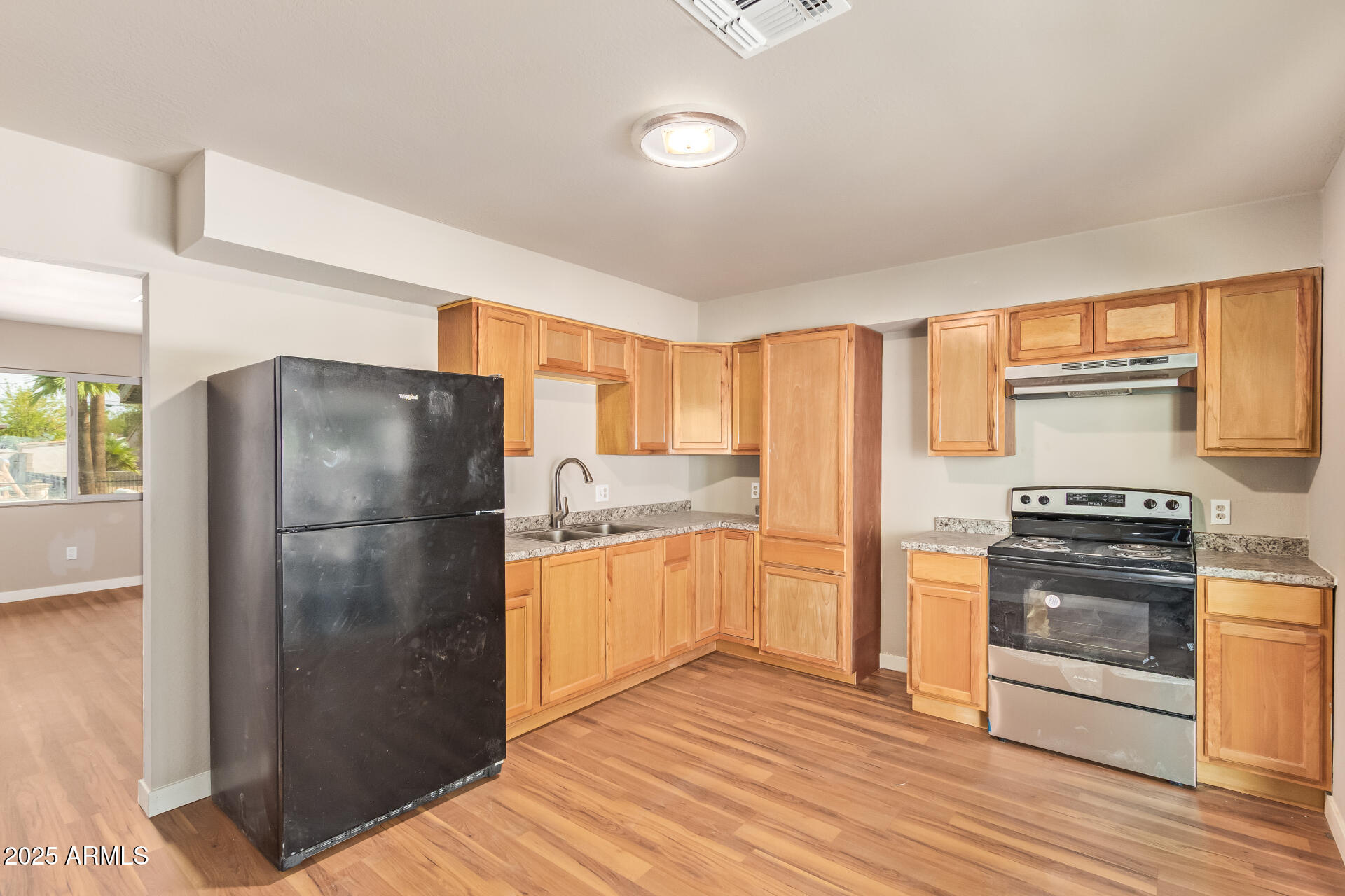 3527 West Almeria Road Phoenix, AZ 85009 - Photo 16 of 32 a kitchen with granite countertop a refrigerator stove and oven