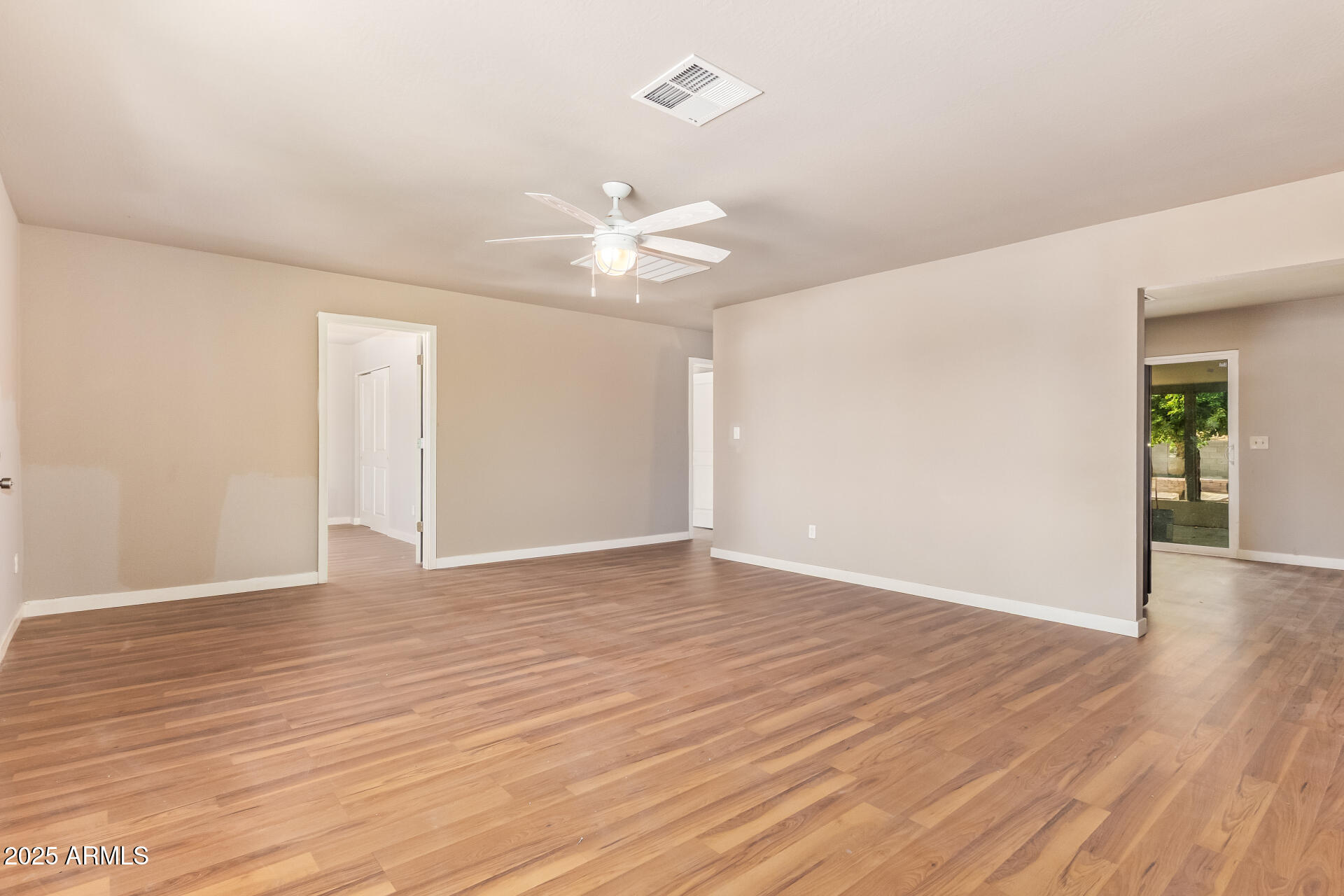 3527 West Almeria Road Phoenix, AZ 85009 - Photo 9 of 32 a view of an empty room with wooden floor