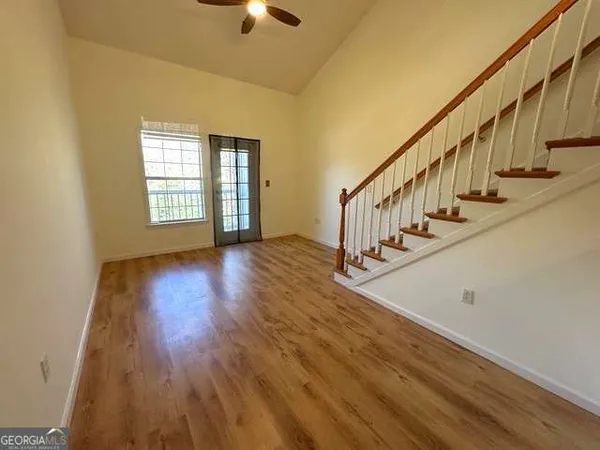 a view of an entryway with wooden floor