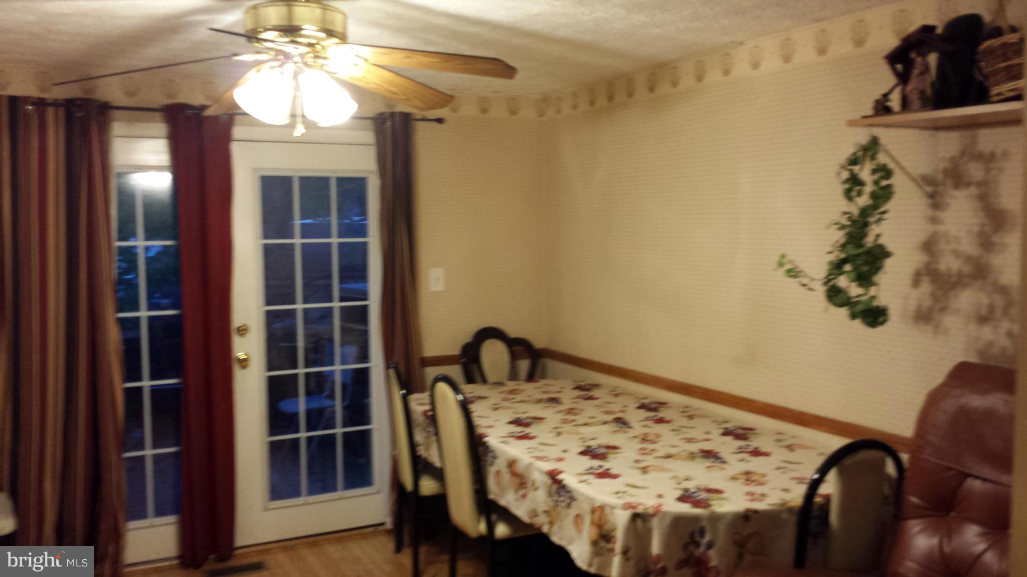 4607 Panacea Road Baltimore, MD 21208 - Photo 13 of 24 a view of a dining room with furniture and wooden floor