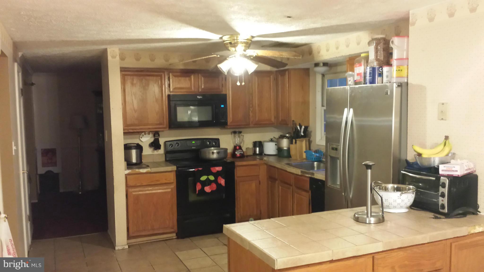 4607 Panacea Road Baltimore, MD 21208 - Photo 15 of 24 a kitchen with refrigerator and a sink