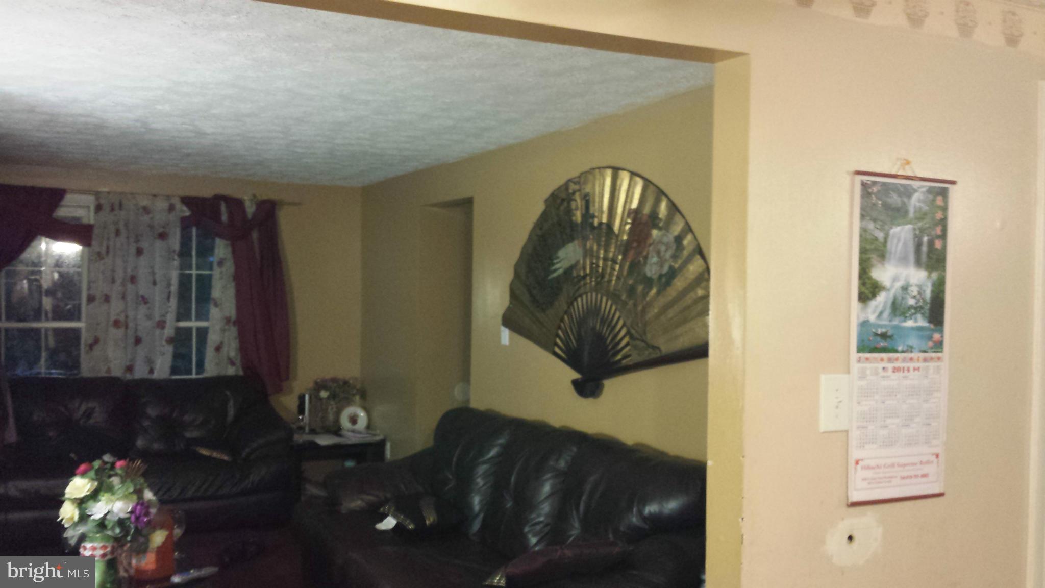 4607 Panacea Road Baltimore, MD 21208 - Photo 16 of 24 a living room with furniture and flowers