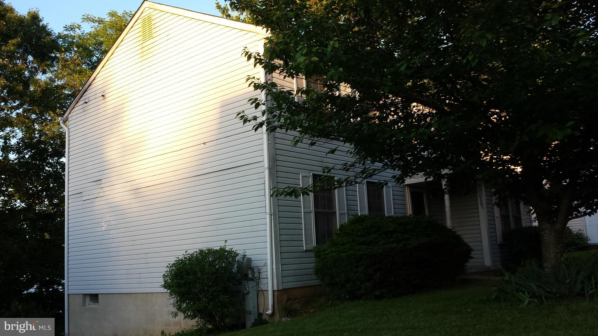 4607 Panacea Road Baltimore, MD 21208 - Photo 5 of 24 a view of house with garden and tall trees