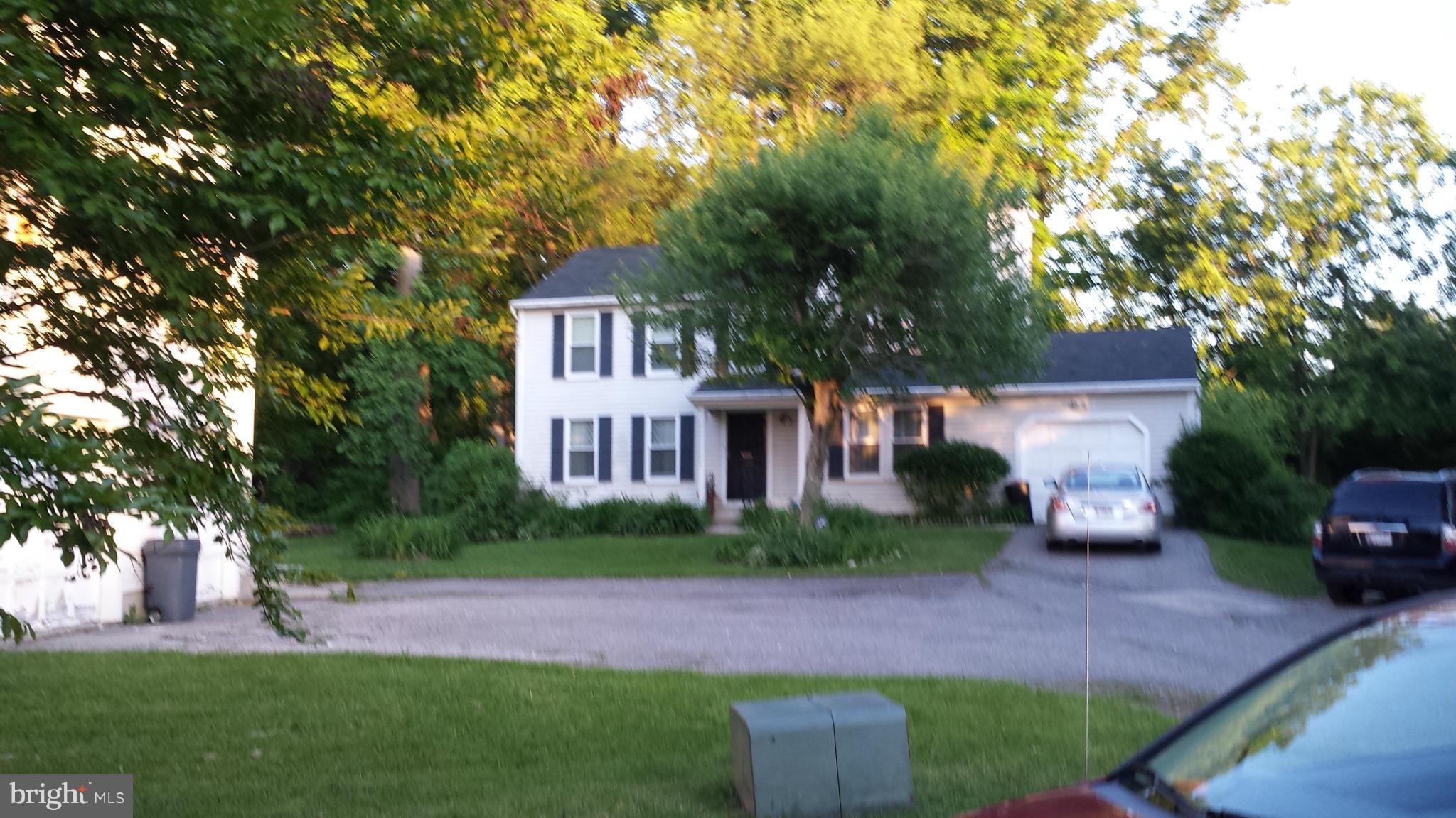 4607 Panacea Road Baltimore, MD 21208 - Photo 8 of 24 a front view of a house with a garden and tree
